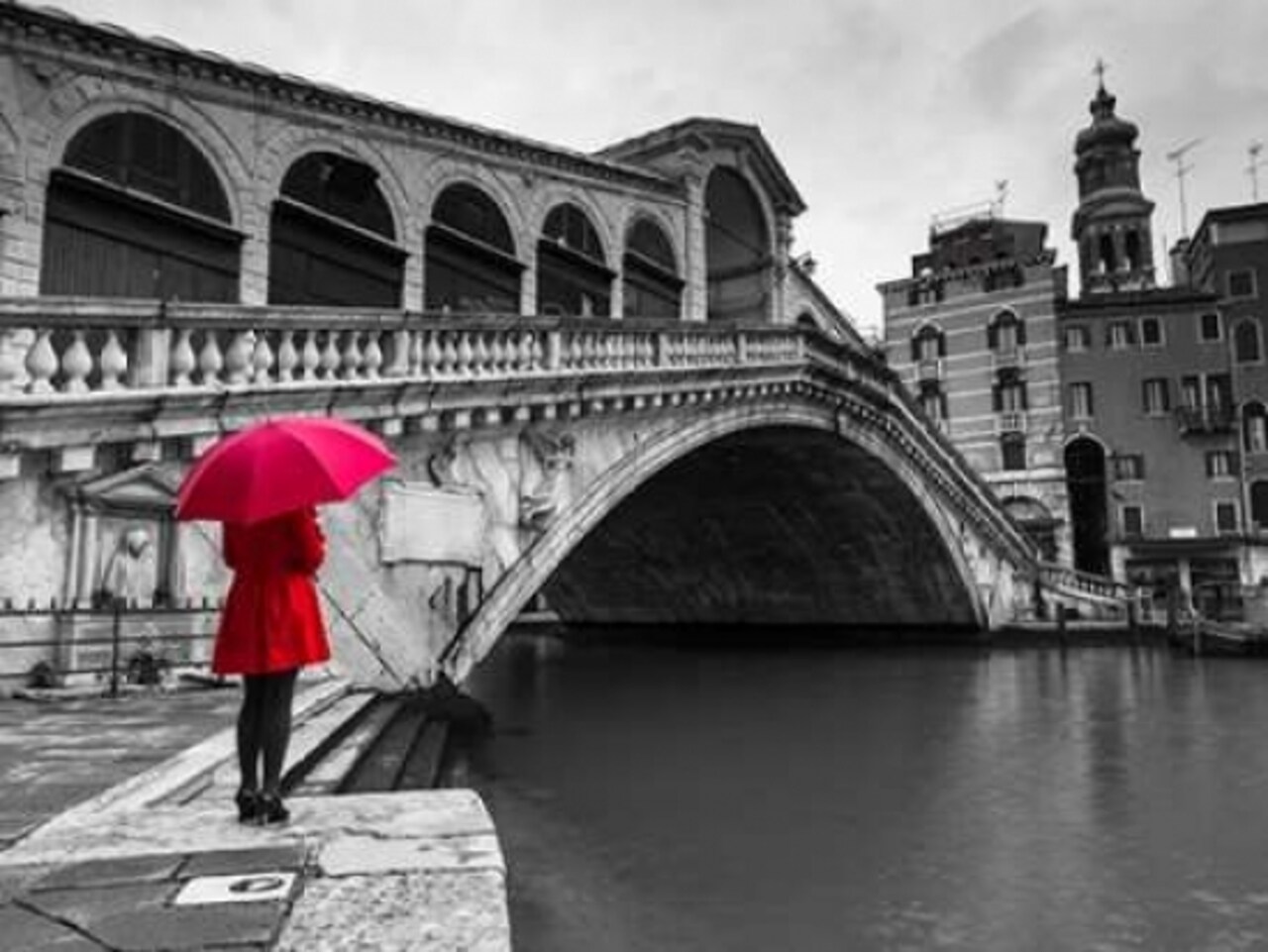 A woman in a red dress holding red umbrella and standing next to the Rialto bridge, Venice, Italy Poster Print by Assaf Frank - Item # VARPDXAF20130409237C03